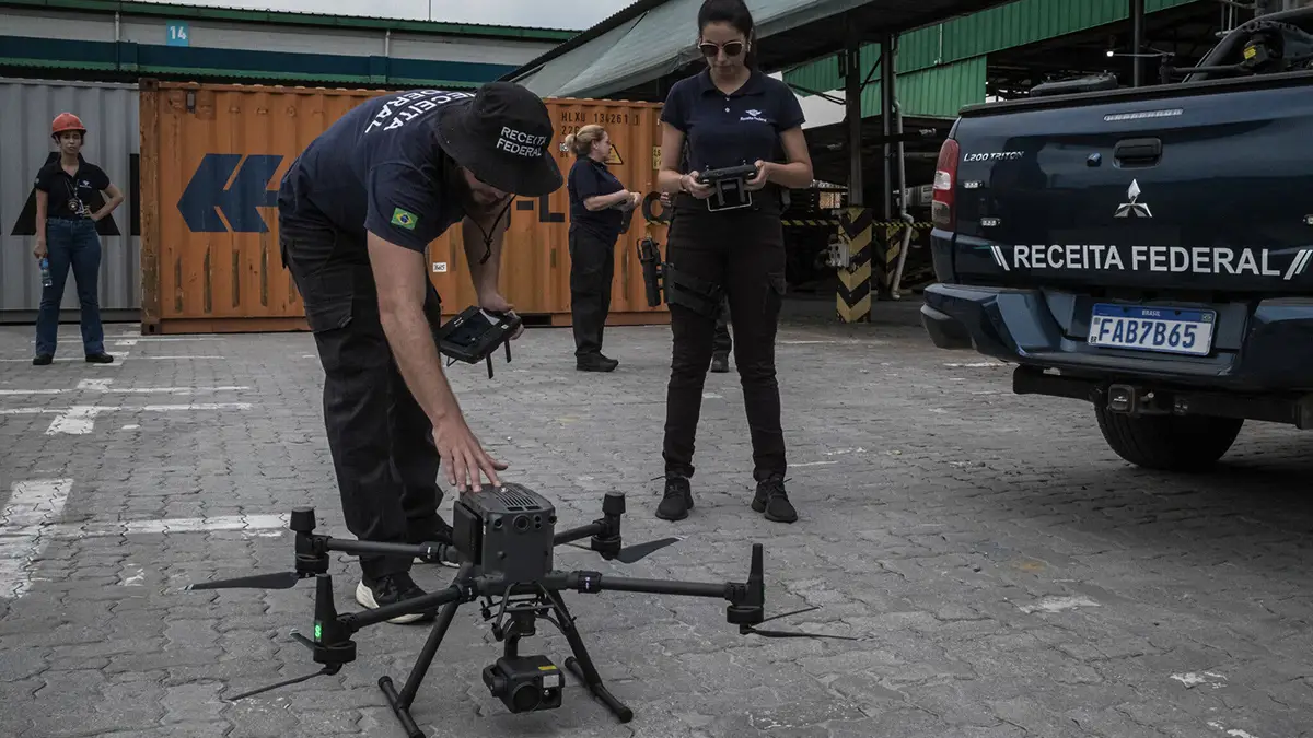 Brazilian Federal Revenue Service officers preparing a drone for flight at the Port of Santos
